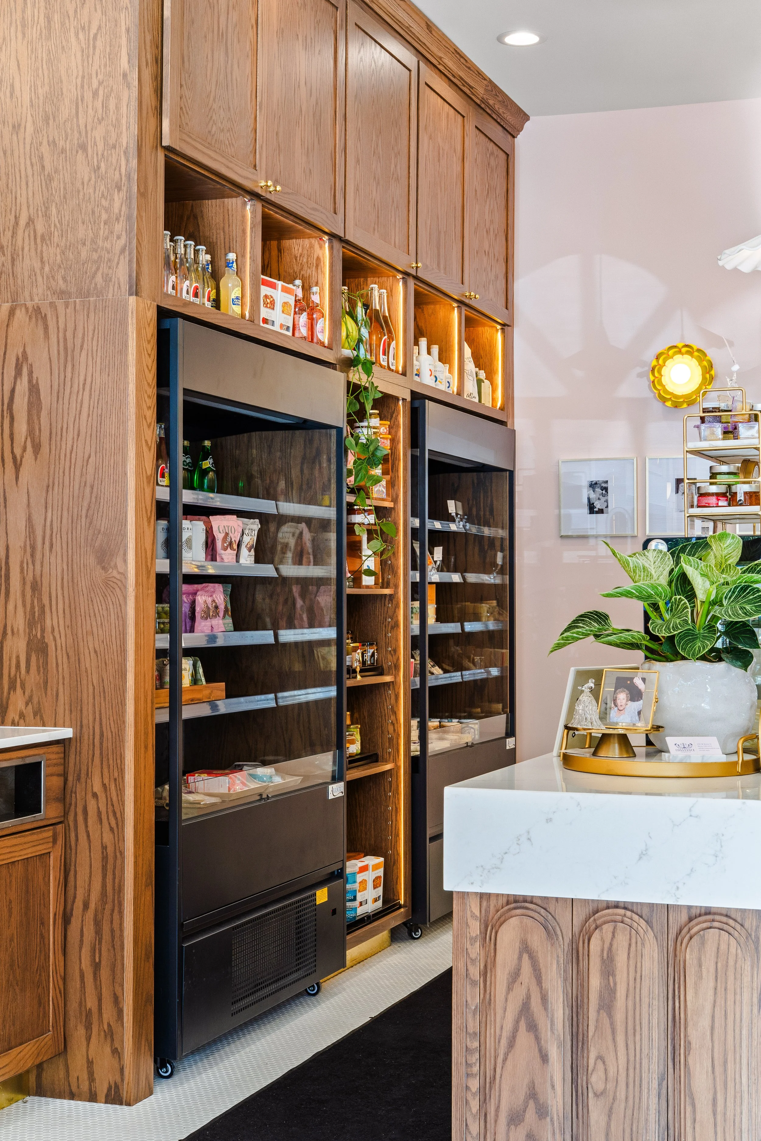 To-go refrigerated area along aisle in front of Constance's charcuterie assembly bar.