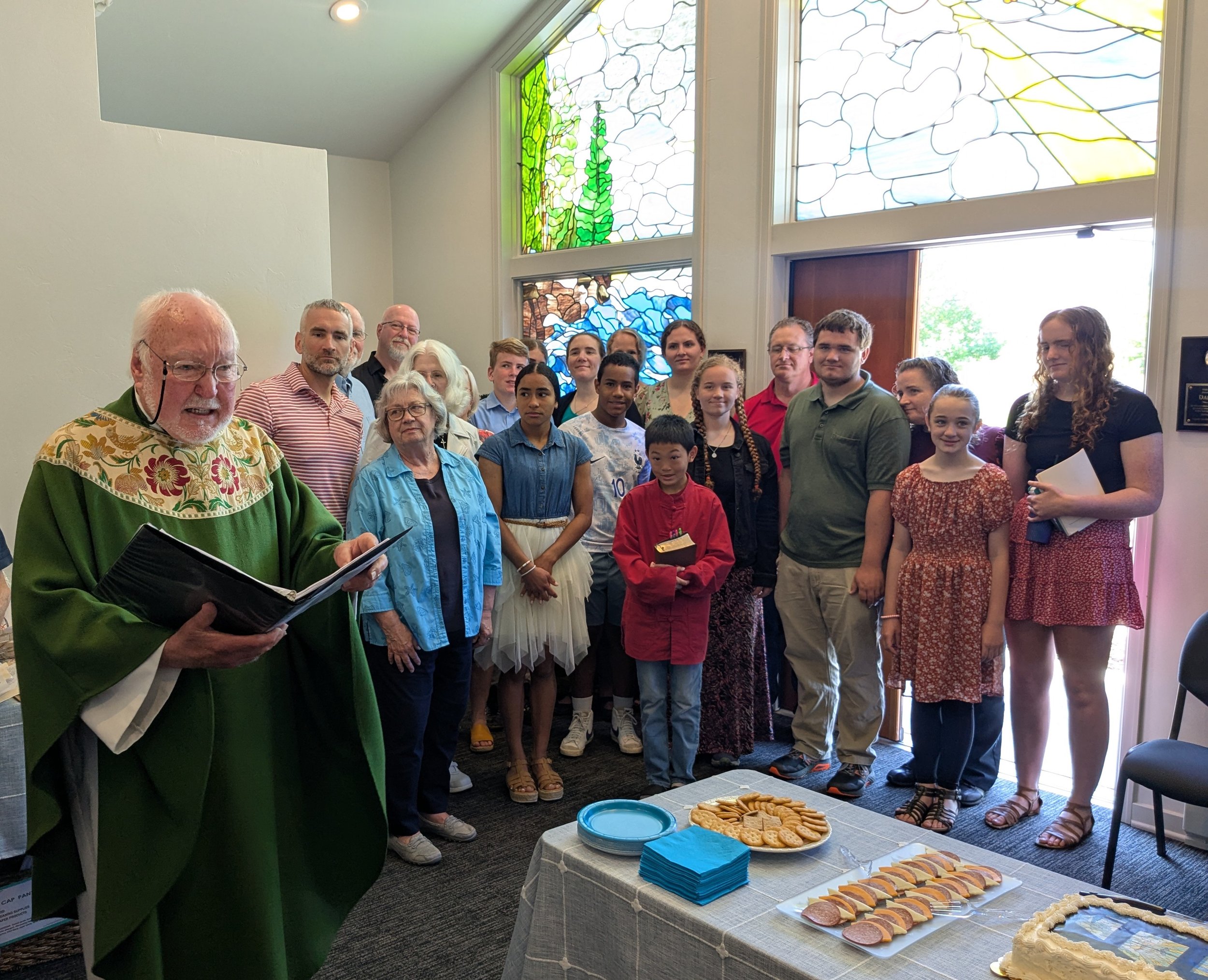 Vicar Olin Sletto offers a prayer of dedication, surrounded by members of the Andreae family.