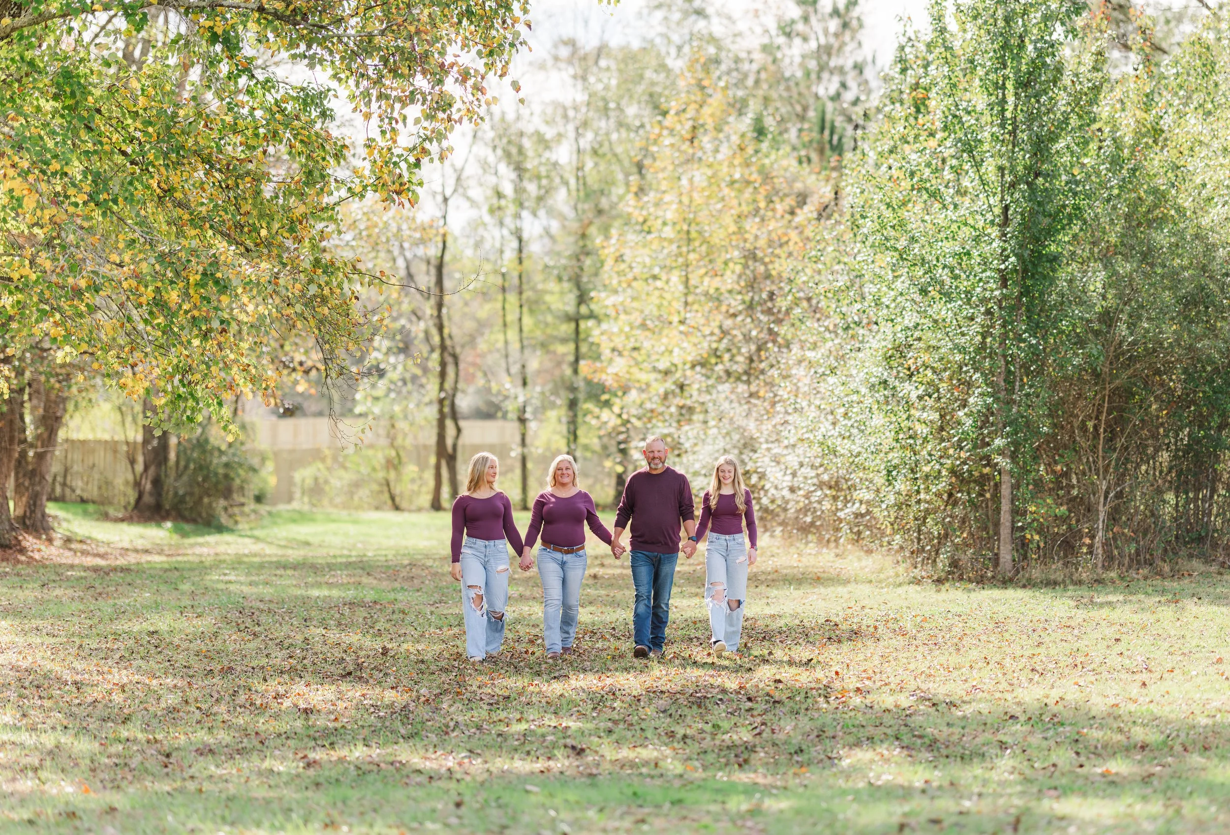 Family of four walking outdoors, photographed by Luther Studios