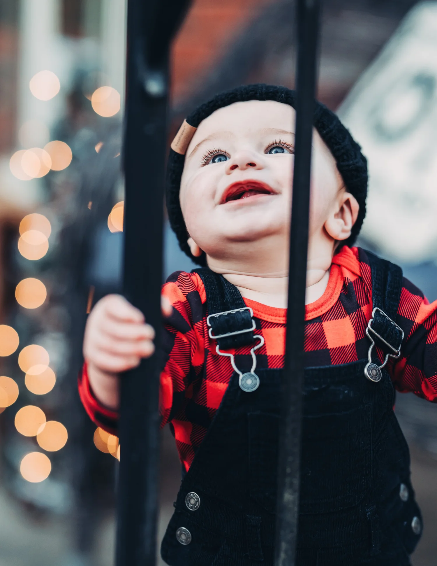 Toddler looking upward beside a railing