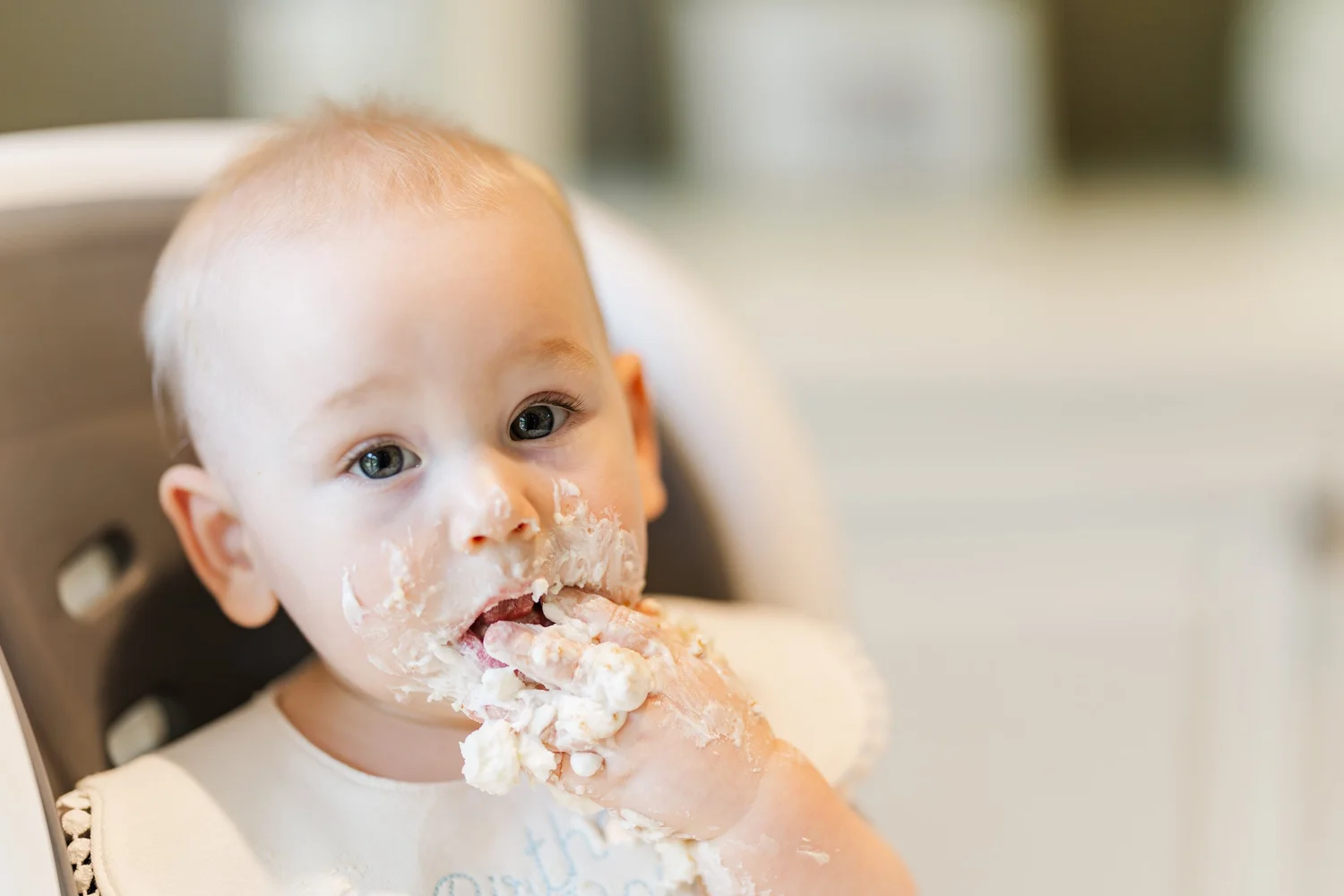 Baby enjoying a first birthday cake