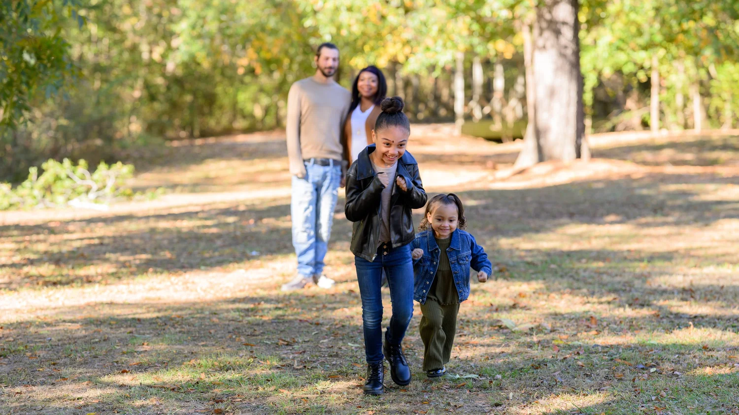 Family and children walking through a park