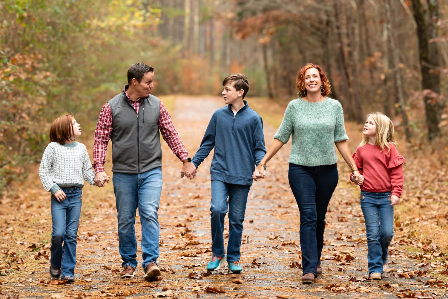 Family walking together along an autumn path