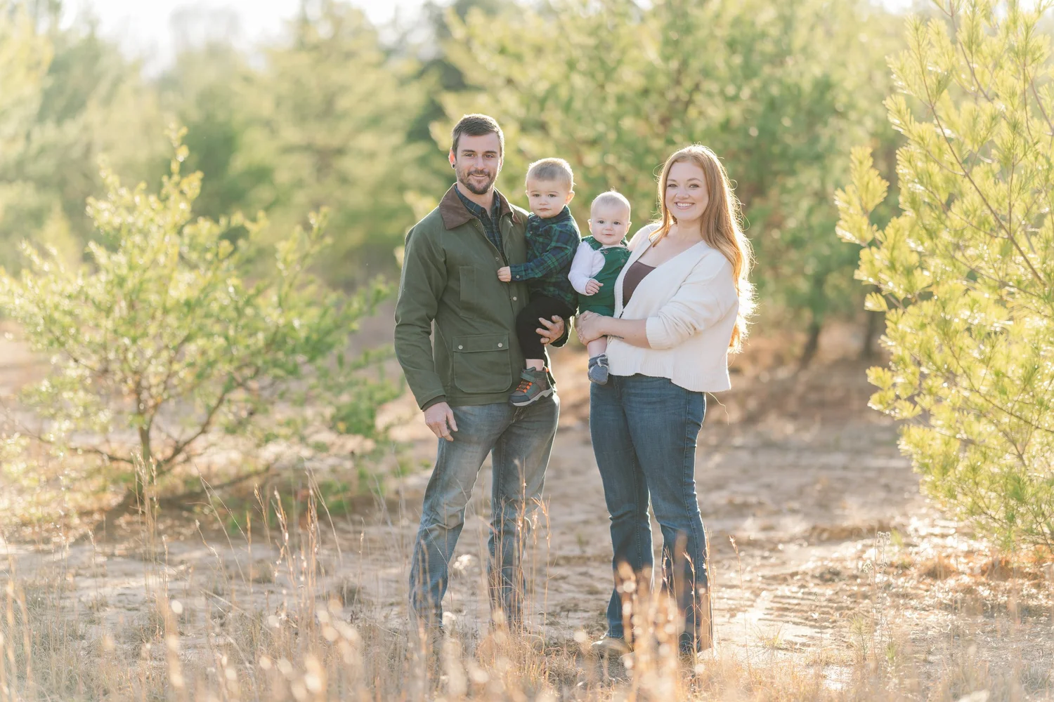Family of four together in warm outdoor light