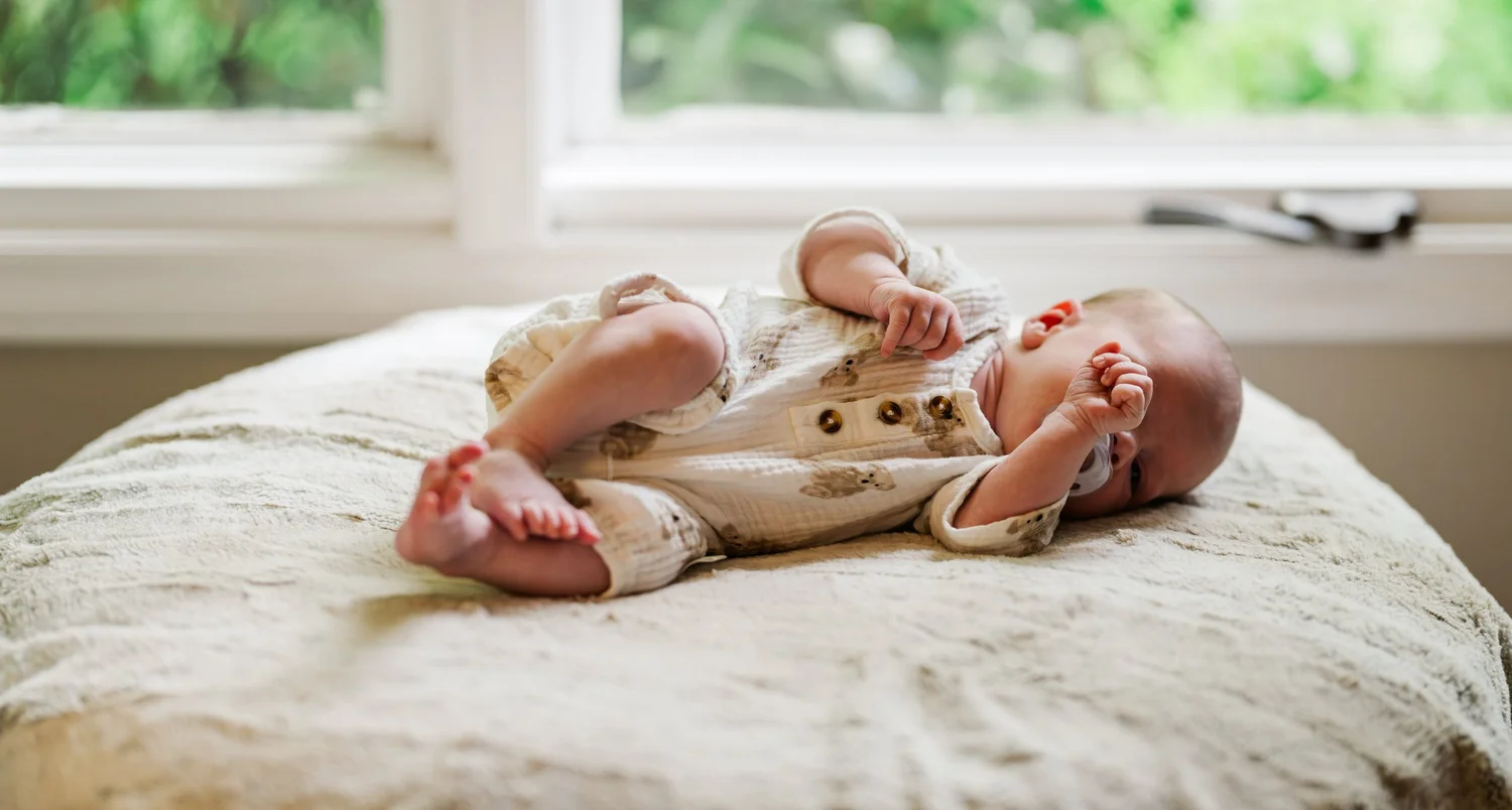 Newborn resting on a soft blanket