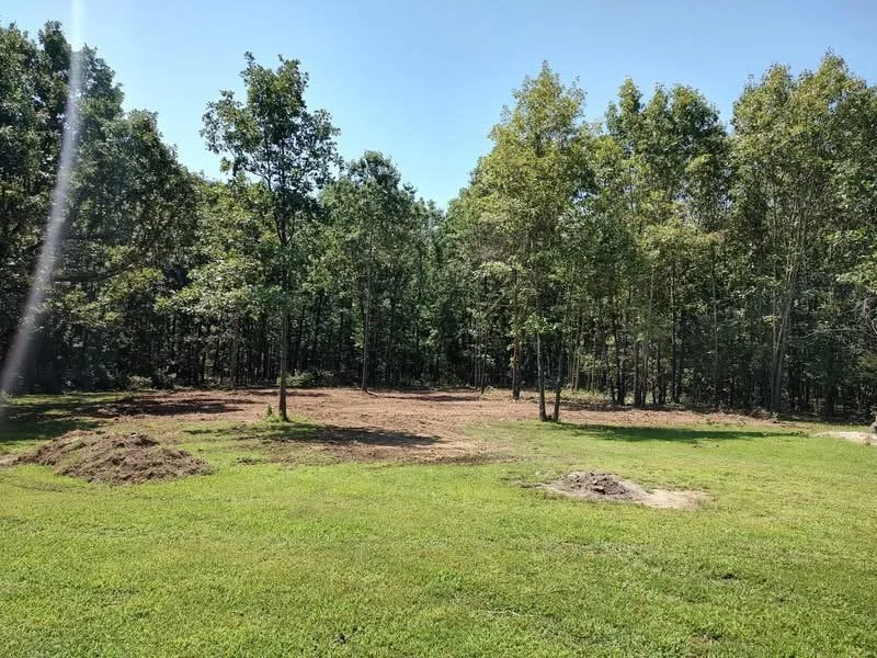 Finished tree removal and graded building site in Webster County, Missouri prepared for septic system installation.