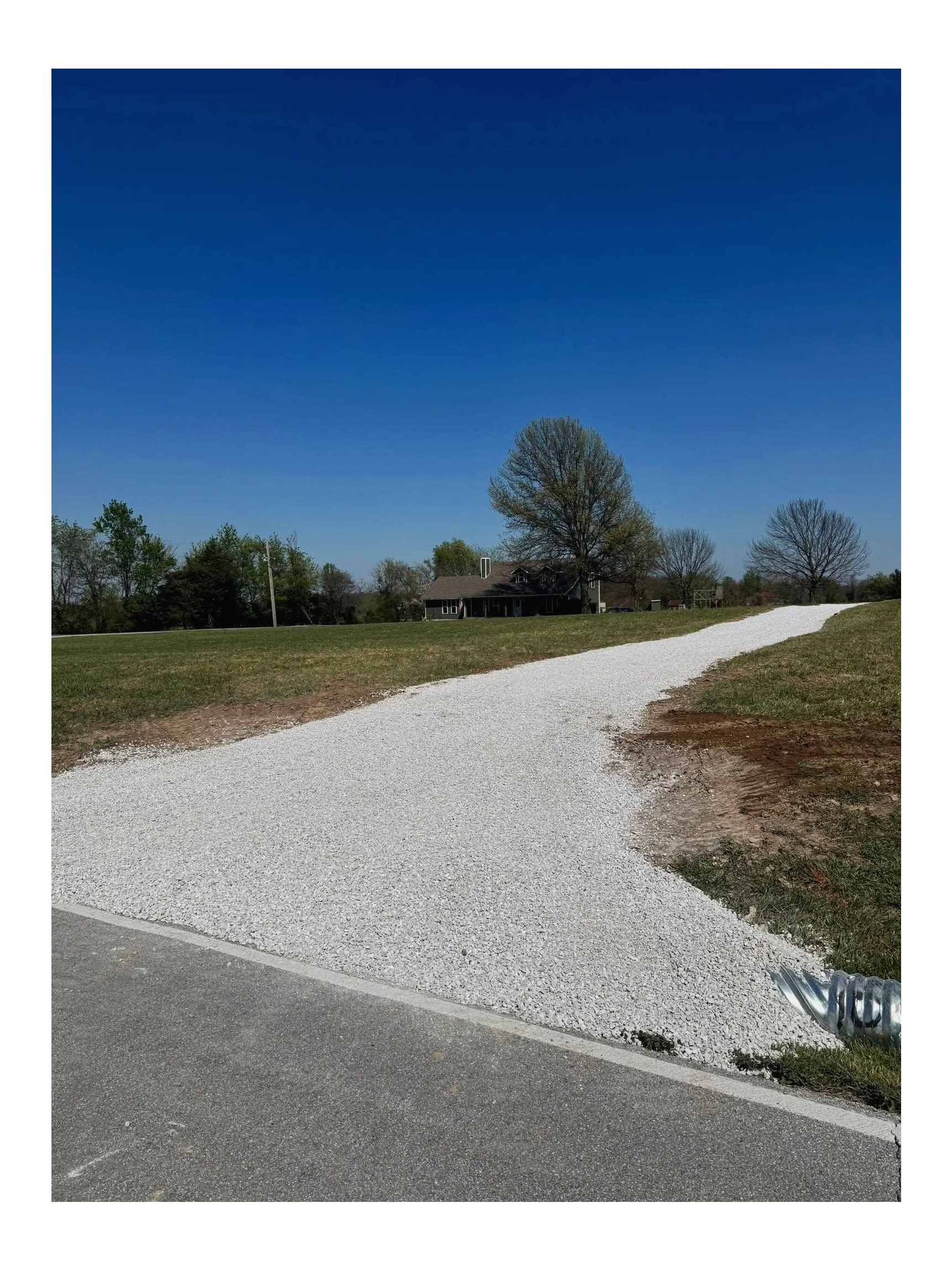 New gravel driveway installation in Willard, Missouri with professional excavation, grading, and drainage improvements for durable property access.