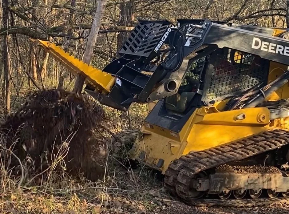 Tree puller removing small trees and brush by the roots for land clearing in Southwest Missouri by T and D Land Management