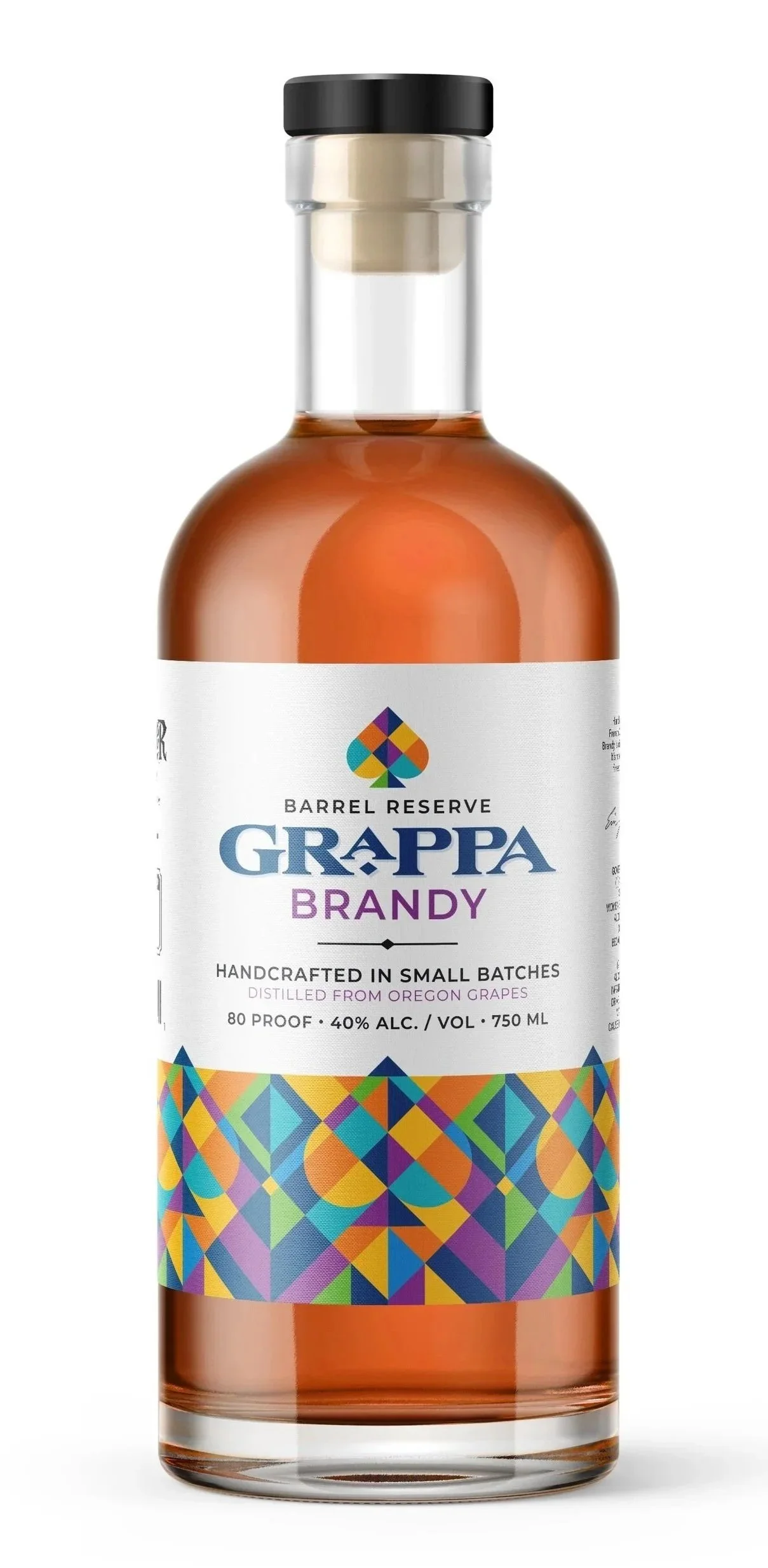 A bottle of Grappa barrel reserve brandy with a black cap, clear glass, and colorful geometric patterned label.