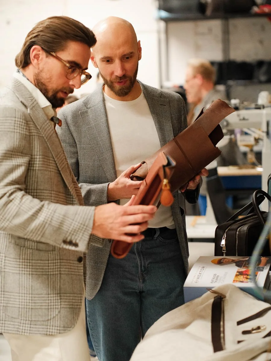 Sartolane founder Mateusz Łochutko with Outfit Narrative founder showing new bag prototypes.
