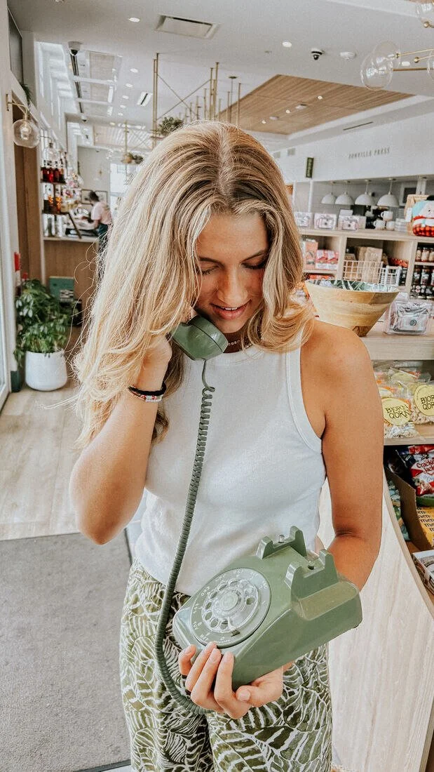 woman answering phone in her store
