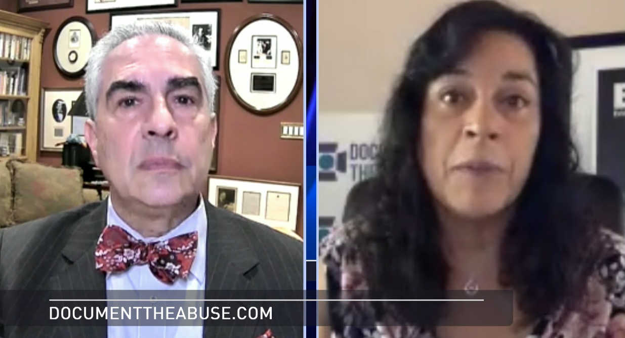 A split-screen video interview showing two people, a man with white hair wearing a suit and bow tie on the left, and a woman with dark curly hair wearing a patterned top on the right.