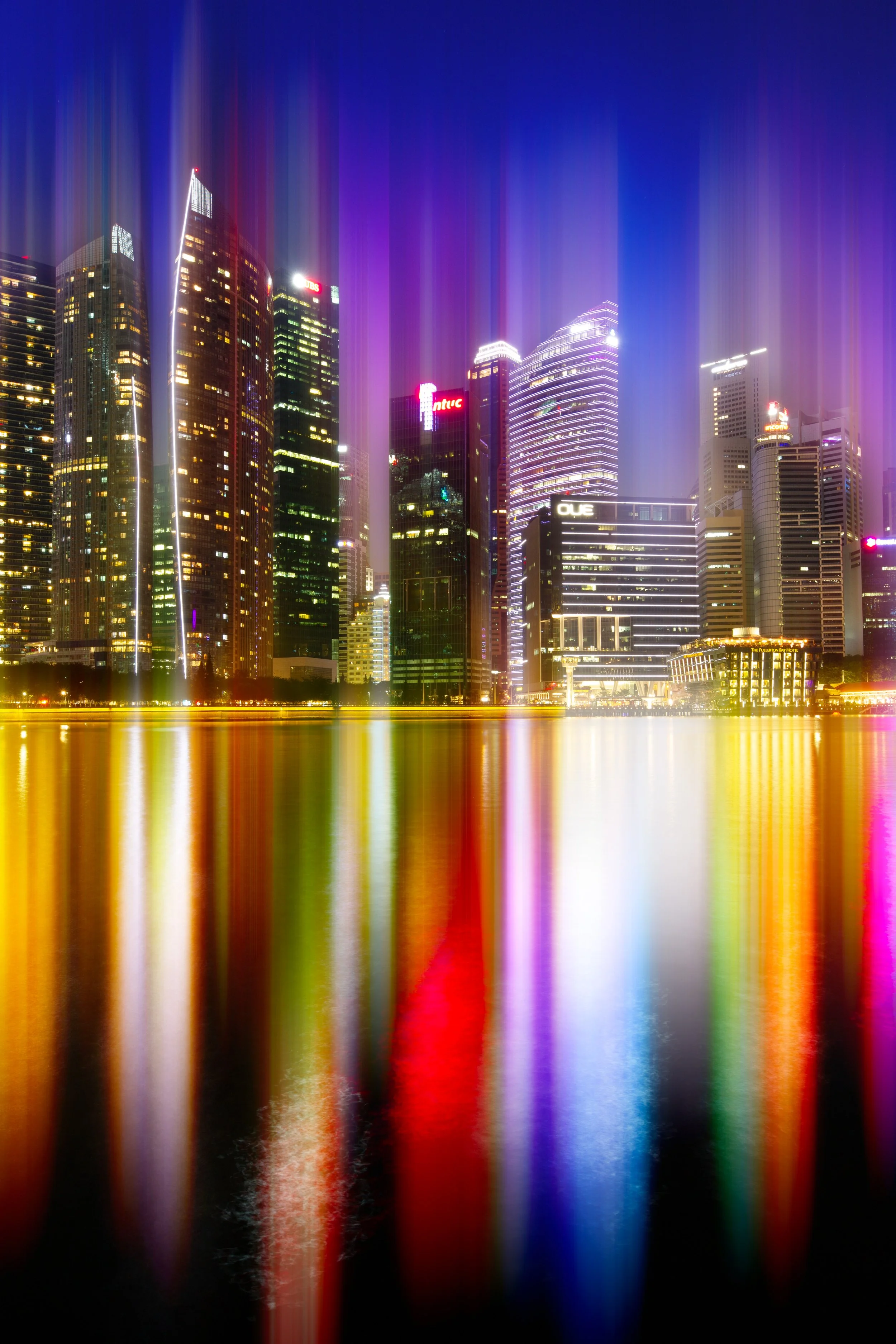 The skyline of Singapore enhanced with vertical shafts of light.