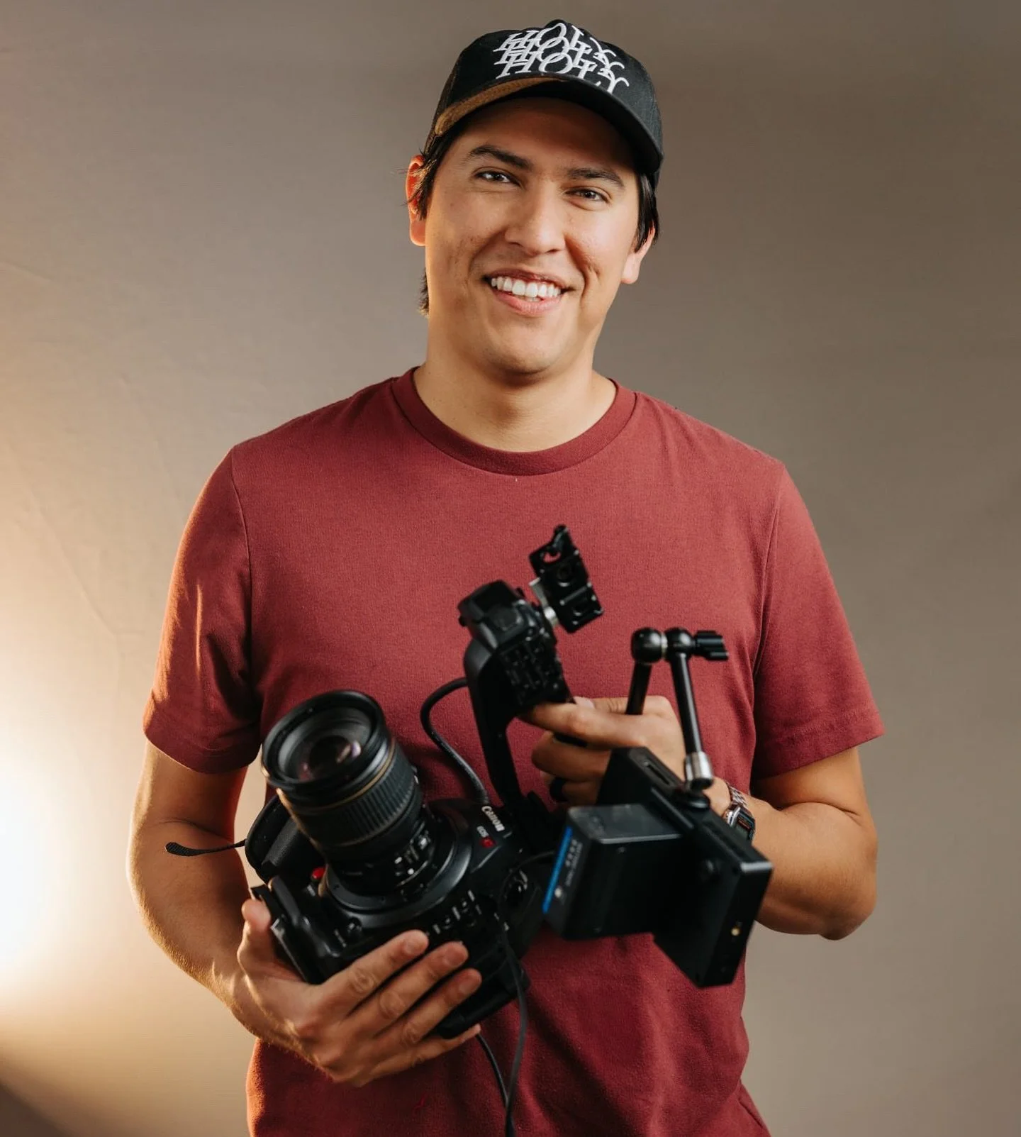 Andres Hernandez, director and founder of El Roi Films, holding a cinema camera