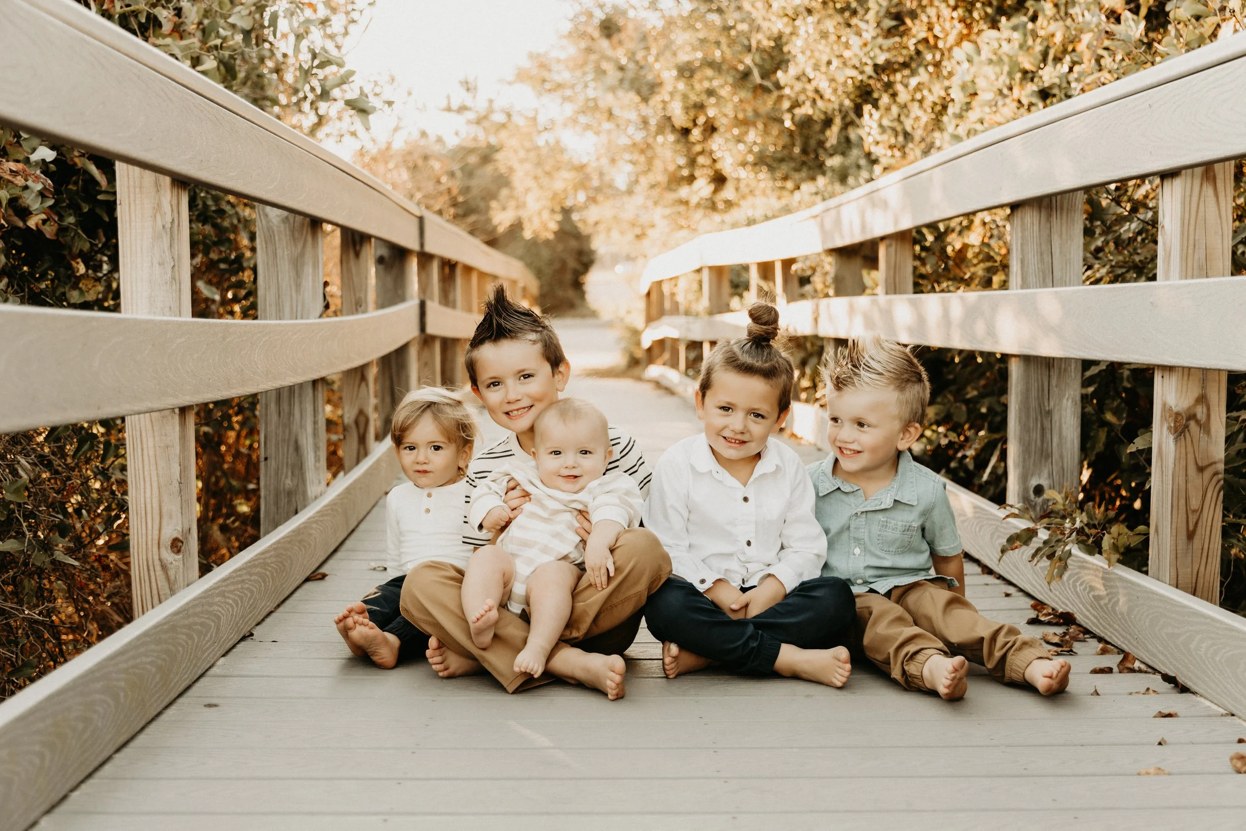 Family of four posing during a photo session in Family of four posing during a photo session in Virginia Beach, VA
