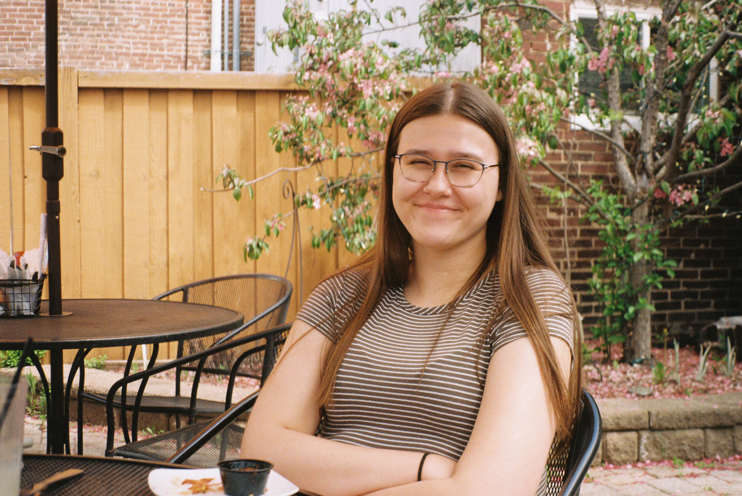 A woman sits smiling