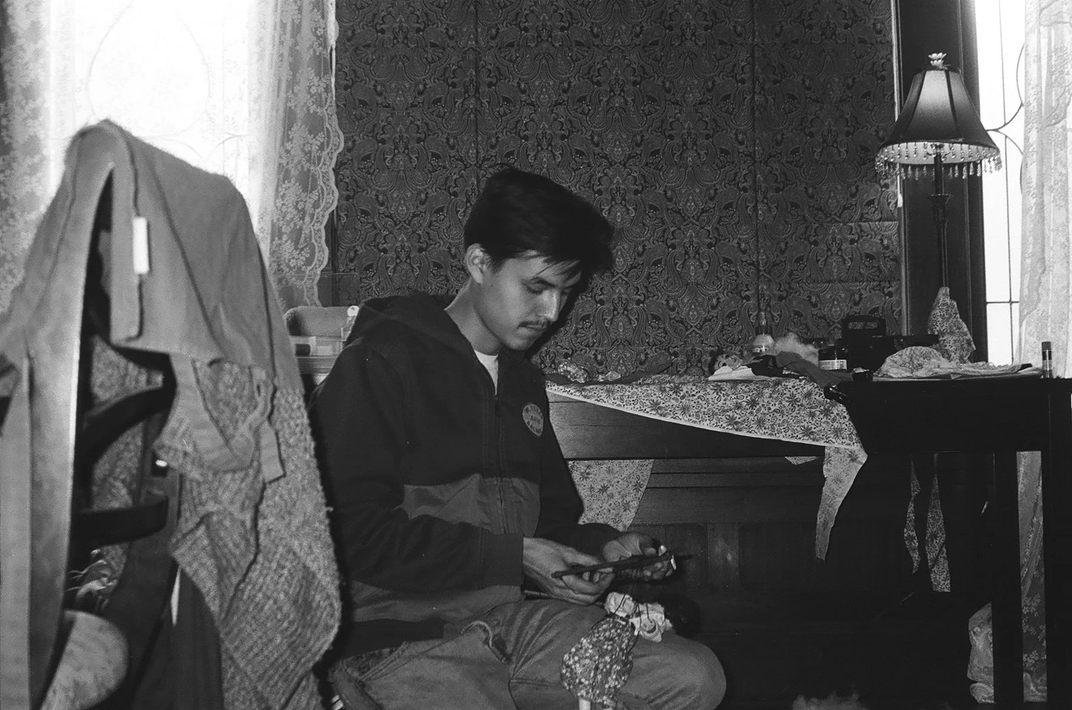 A man sits looking at his hands