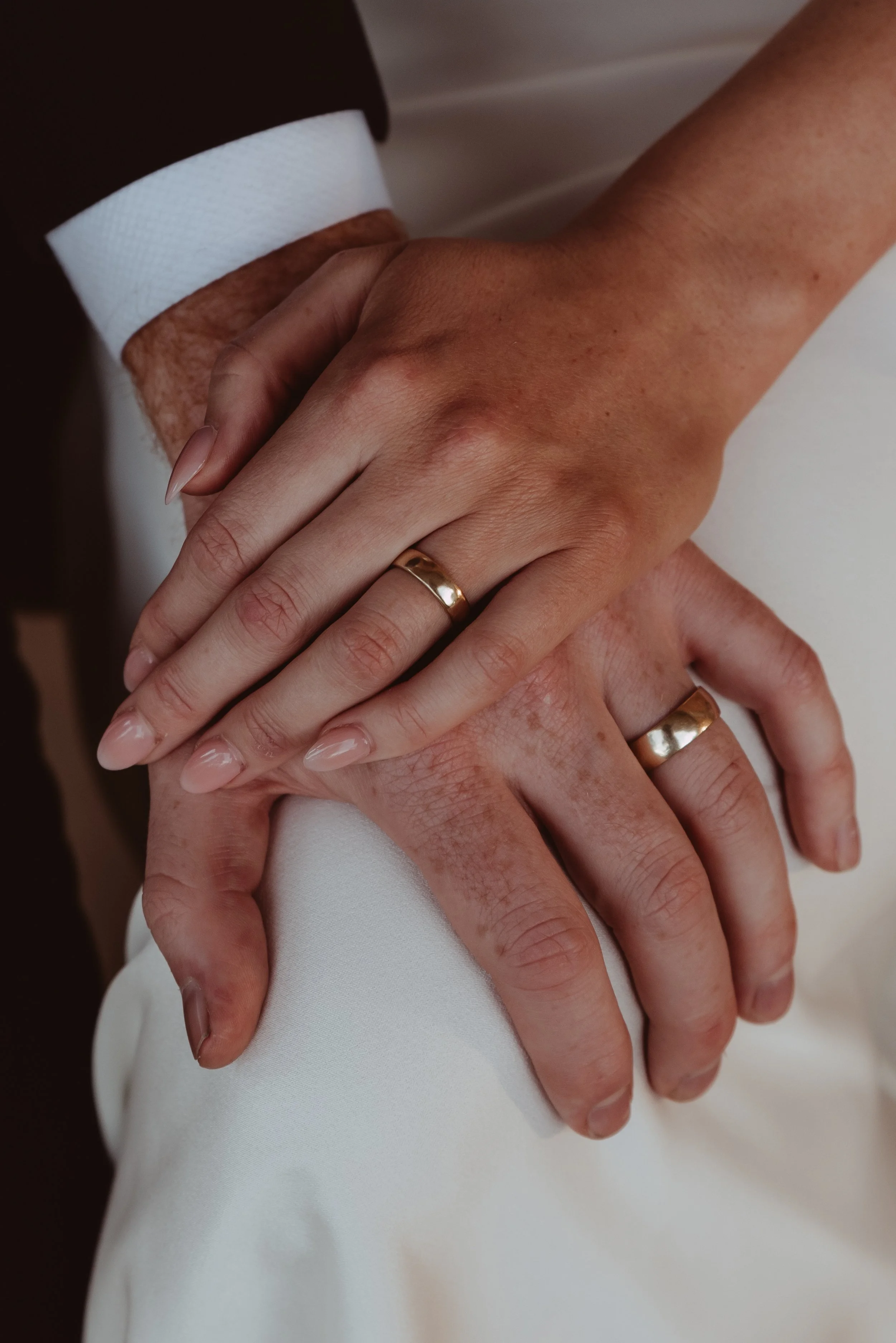 close up of two hands with their custom made wedding bands at their Braidwood elopement