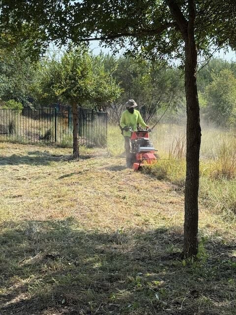 A Dynamo Dusty’s operator uses heavy-duty brush mowing equipment to cut tall grass and overgrown vegetation on a property in Kyle, Texas. Our land management services help maintain acreage, ranchland, and undeveloped lots across Central Texas.