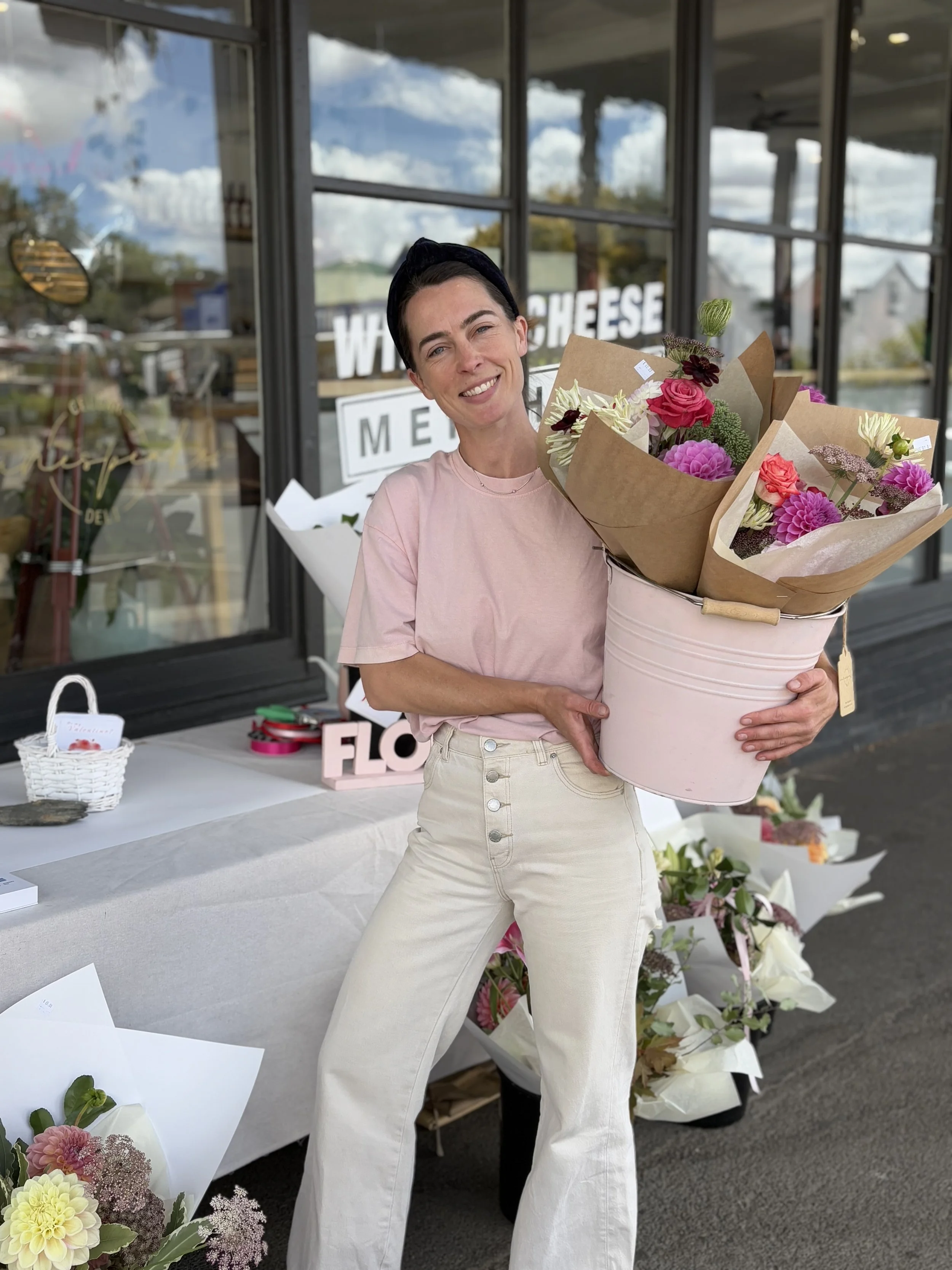 Florist holding bucket of flowers