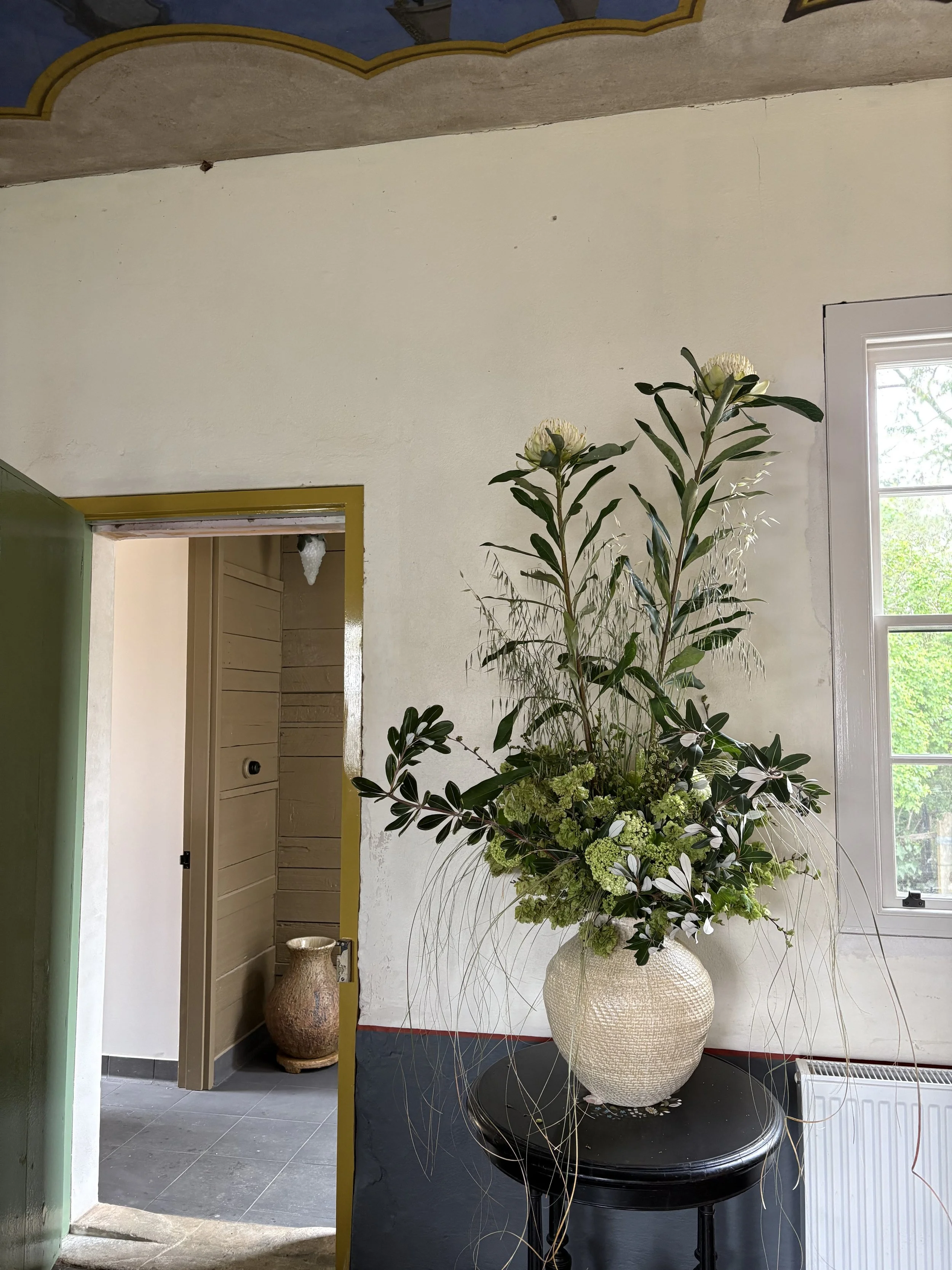 large vase arrangement in cafe