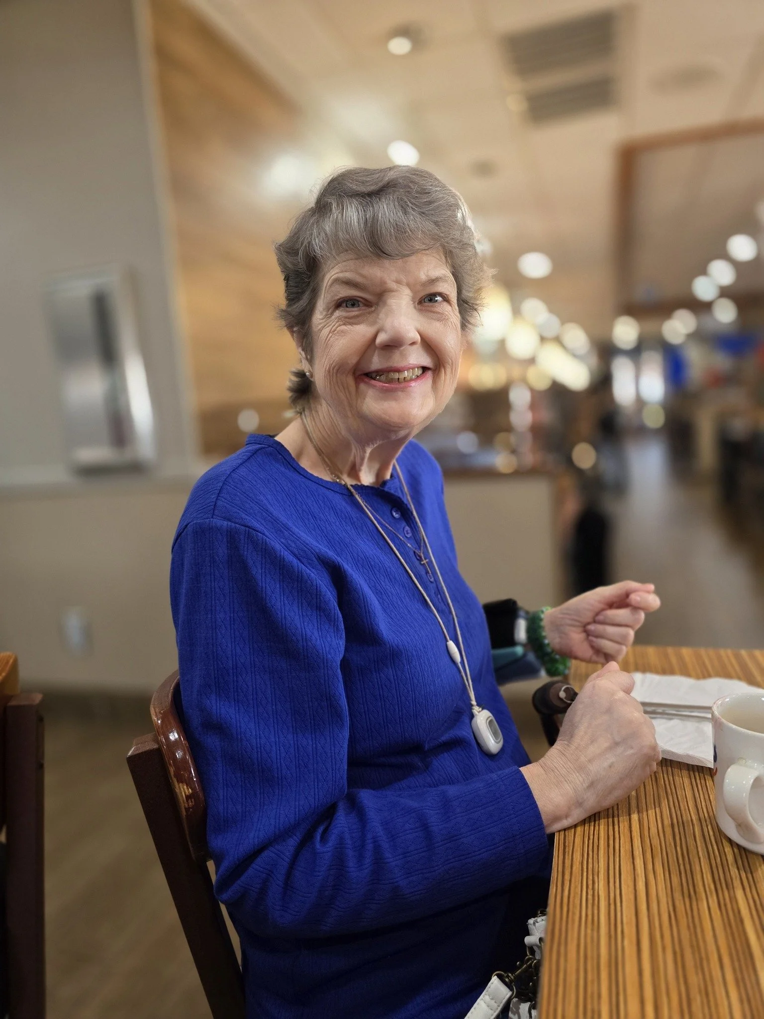 Smiling lady in blue shirt