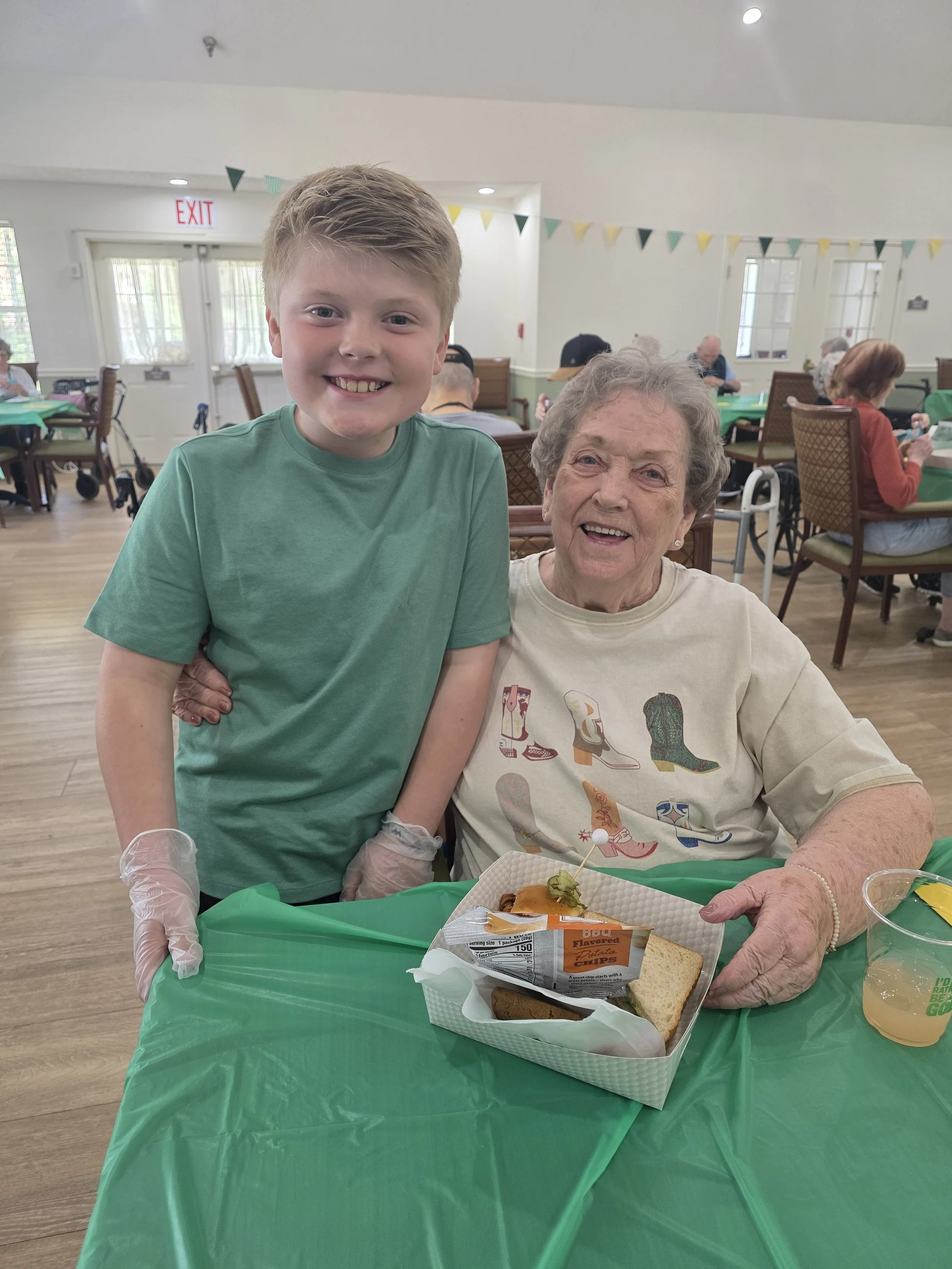 Siling young boy with older lady