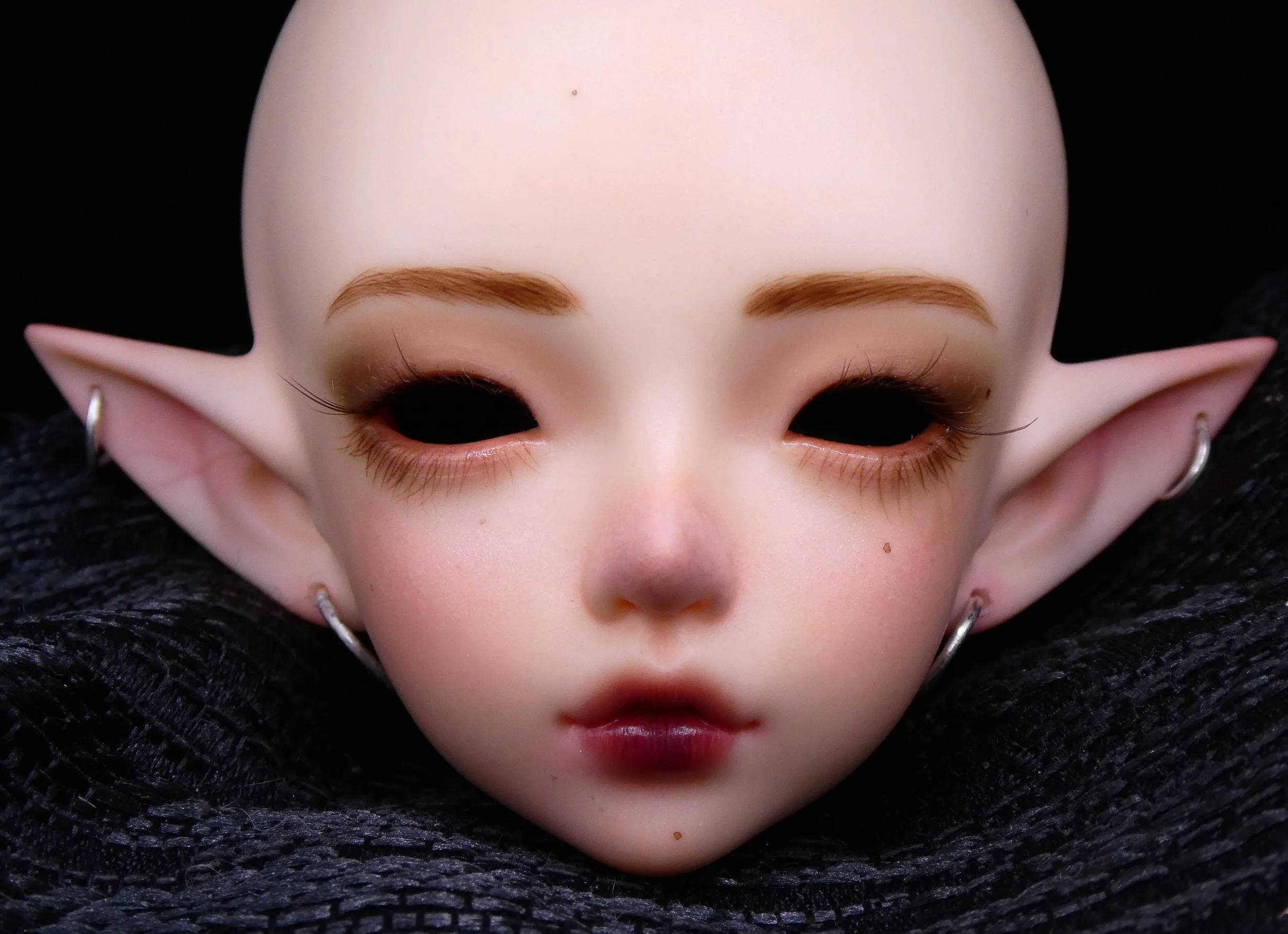 Minifee Phoeb
 
Painted in a glamorous but semi-natural style with piercings.