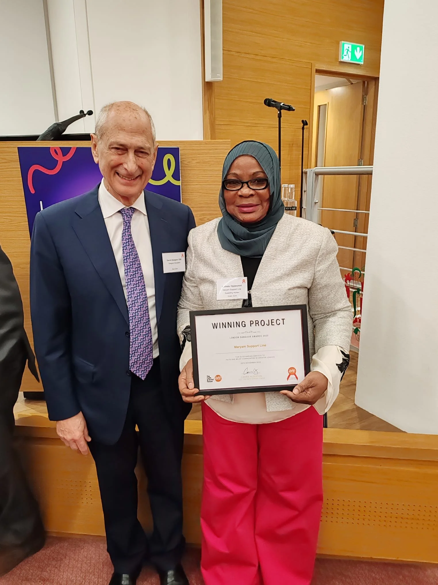 David Dangoor CBE presenting an award to Maryam Support Line