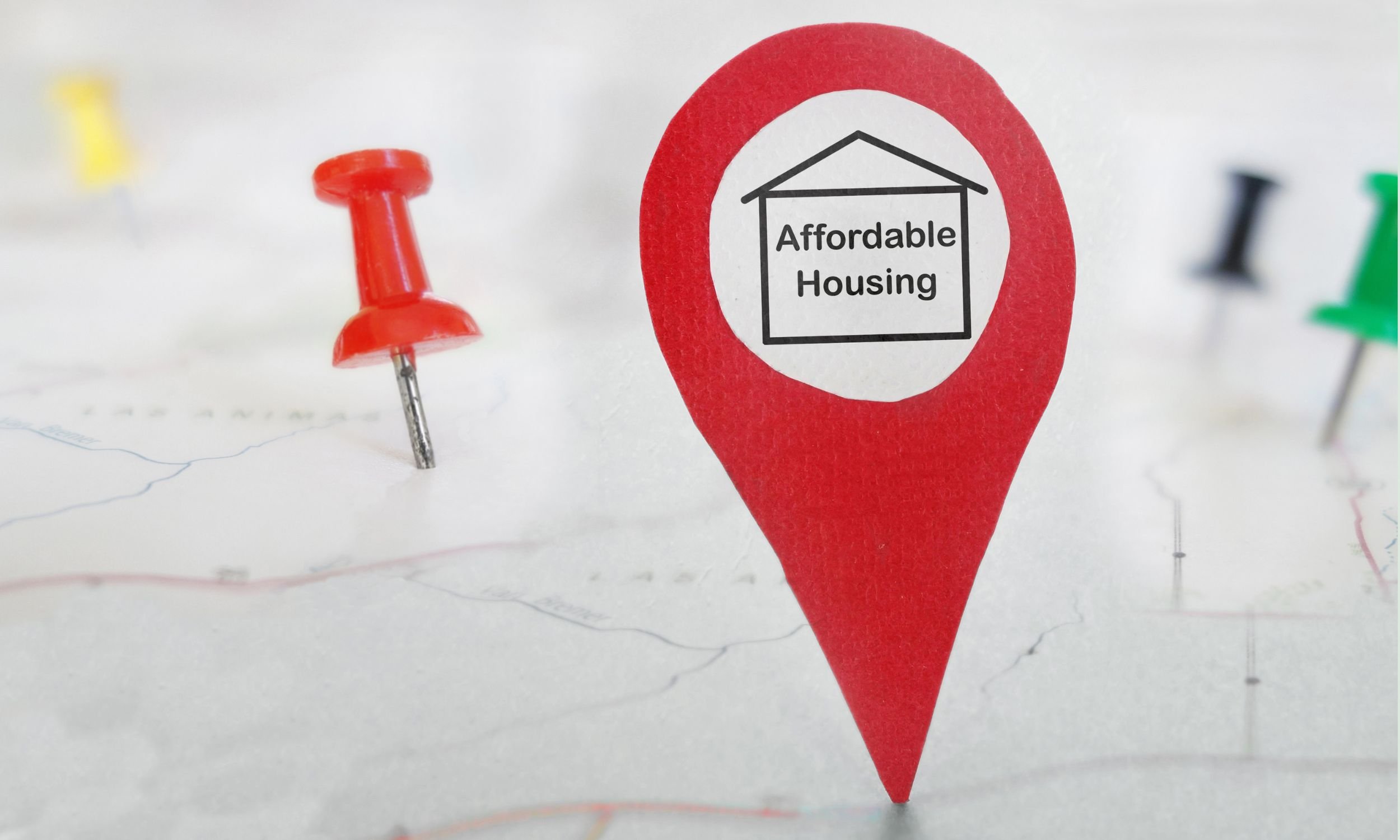 Diorama of a location symbol containing a graphic of a house with 'affordable housing' printed inside.