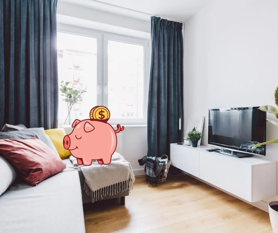 Modern cozy living room with sofa, TV, and natural light, featuring cartoon piggy bank graphic representing smart rental budgeting in the GTA