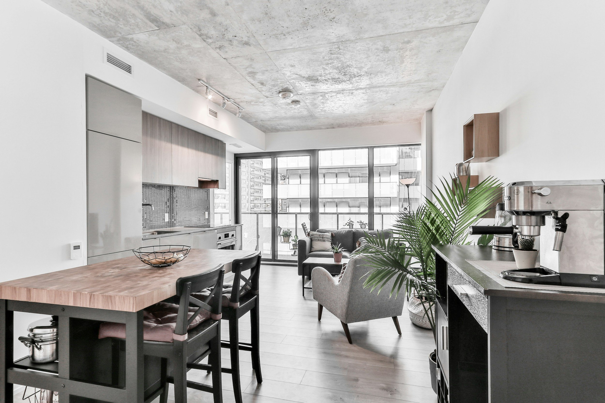 Bright, modern condo with a bartop table, coffee nook, and reading chairs