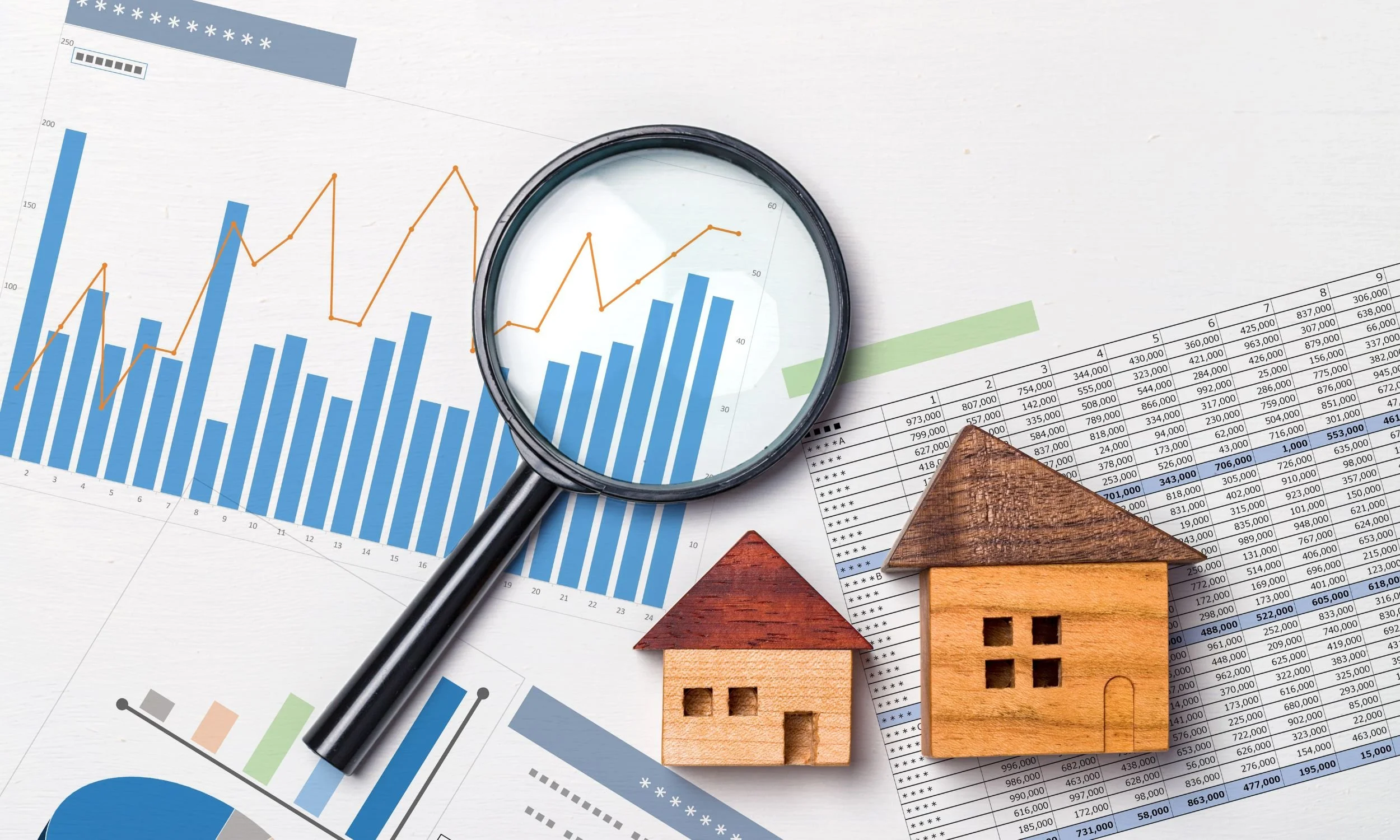 Diorama of sheets of paper with graphs and tables, featuring a magnifying glass and two small wooden houses on top.