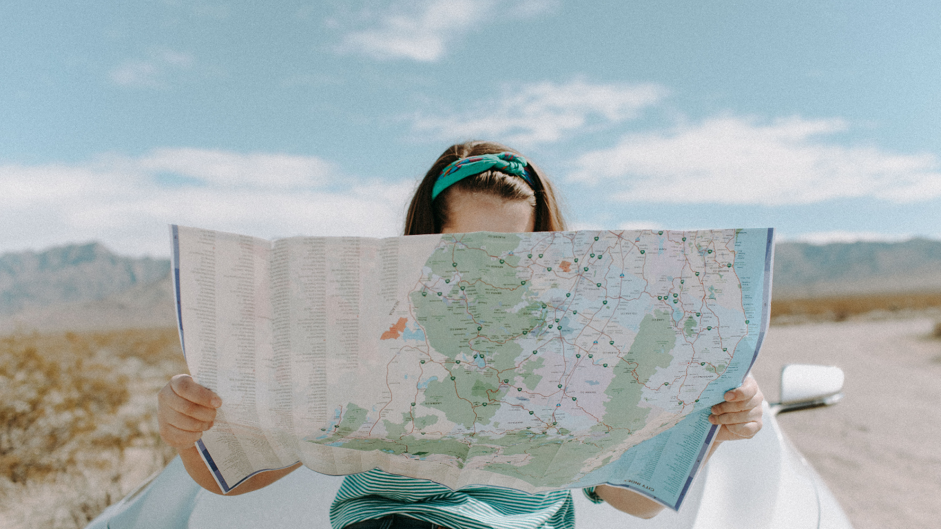 A woman holding and reading a map