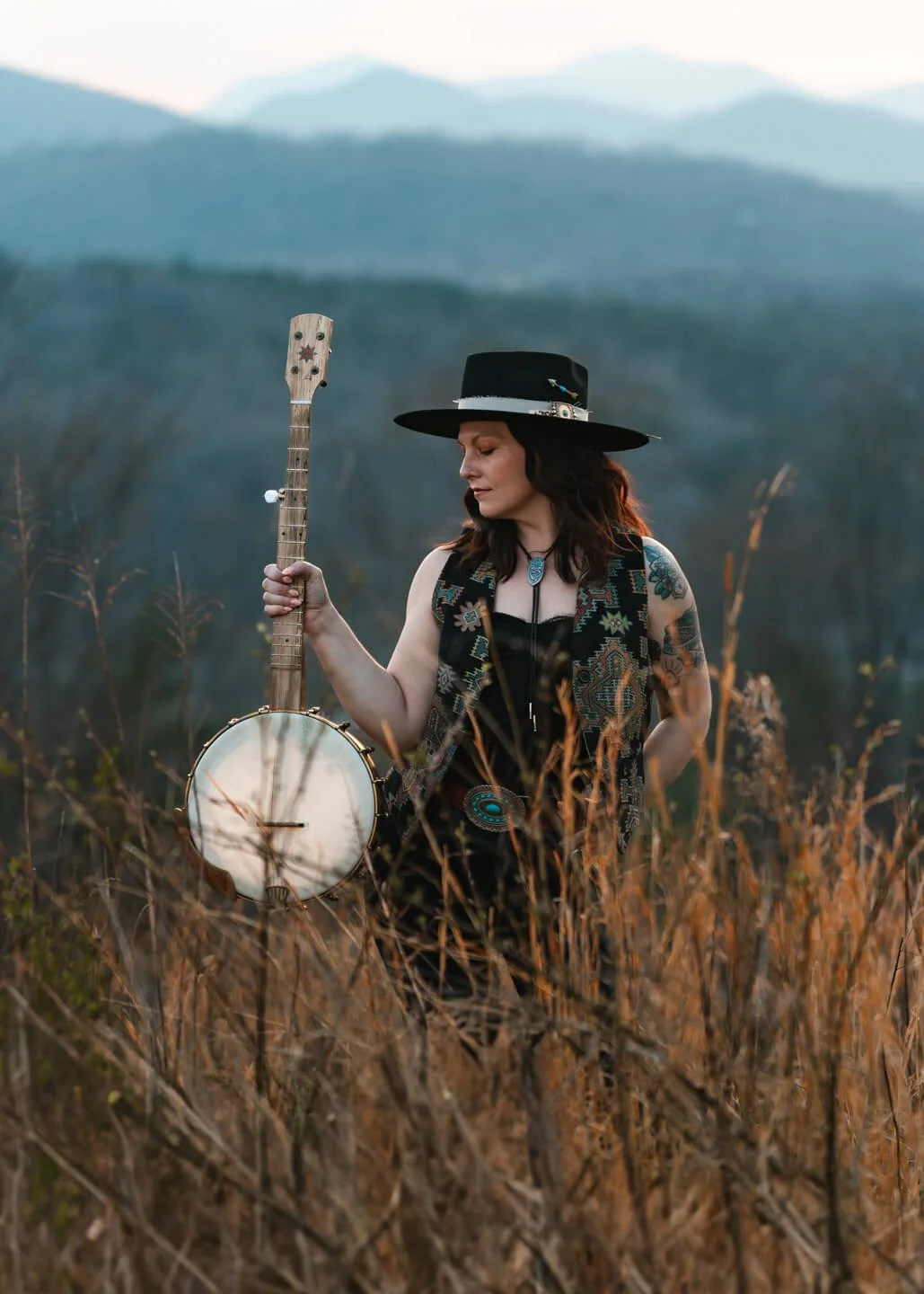 Branding portraiture for local Asheville musician Sonata Lee Cantata. Bringing the Folk bluegrass style into the frame with the Blue Ridge Mountains of Asheville, NC. Creative branding photography by Asheville Elevated Photography.