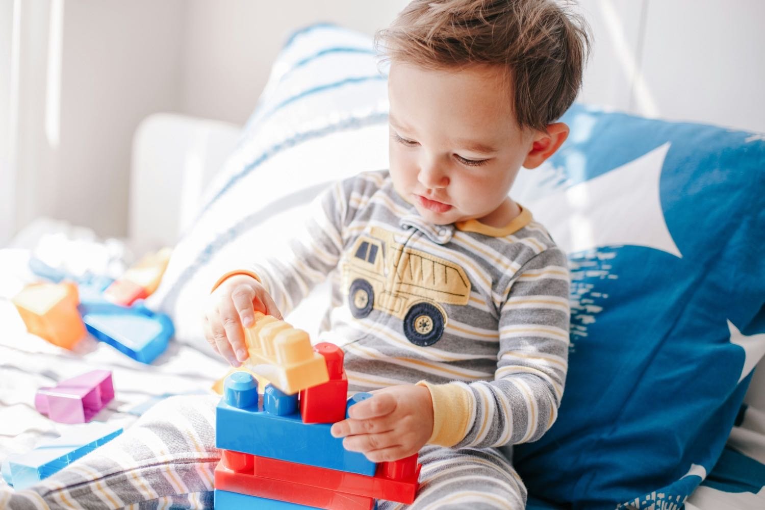 Toddler playing with colorful blocks.