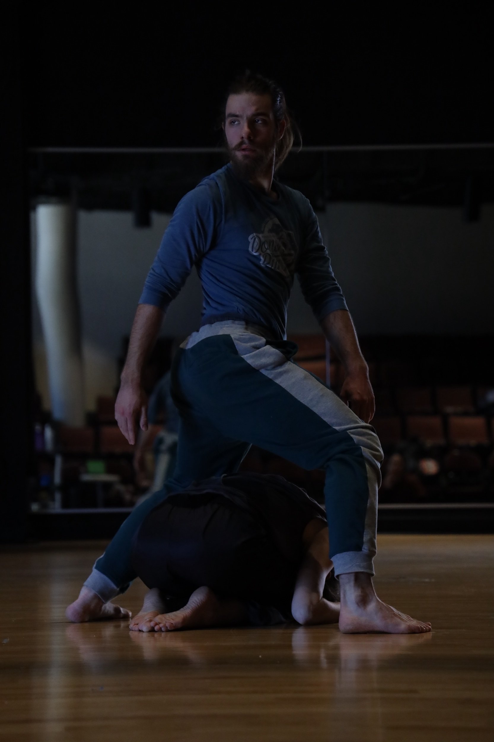 Andrew in plie open stance looking back