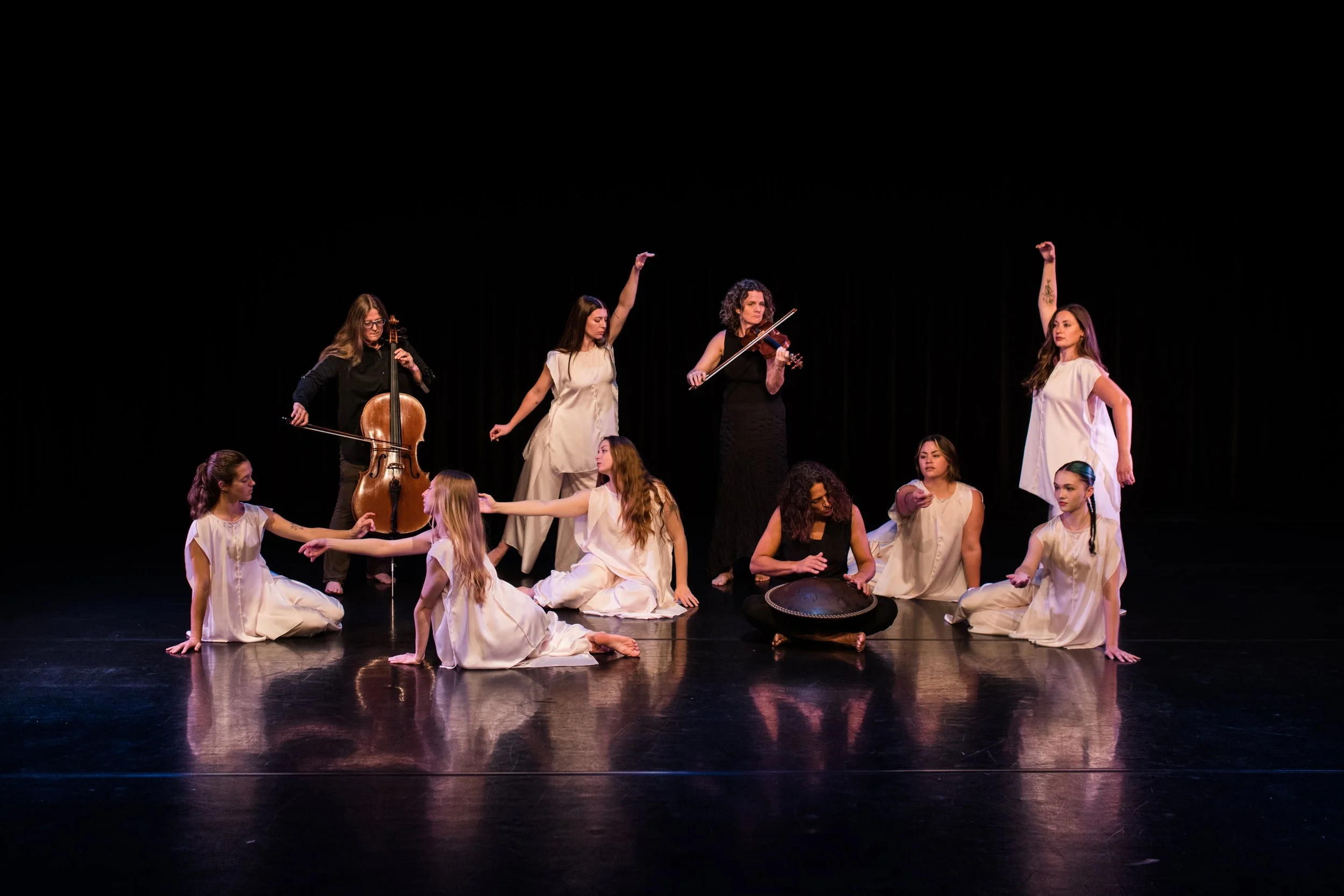 Dance performance with dancers in black and silver costumes on stage with the text 'Season 46 Fall Concert of Dance' and the Wellspring logo.