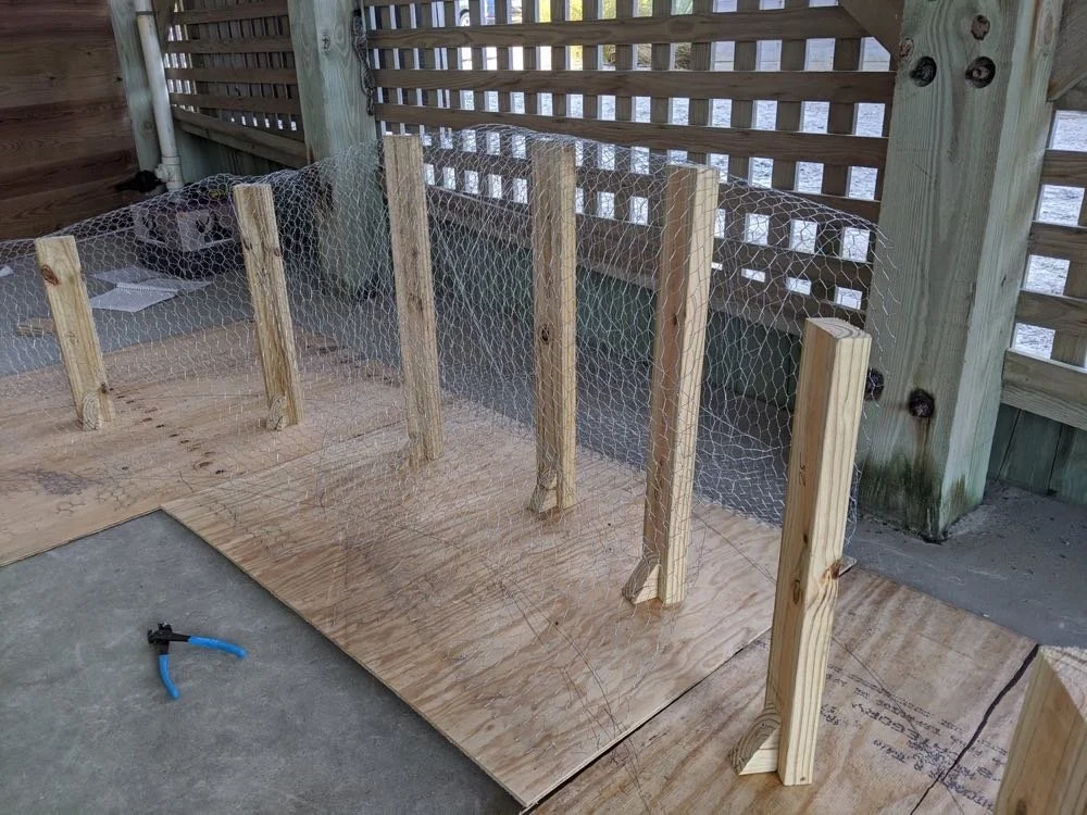 Wooden posts and mesh wire on a porch.