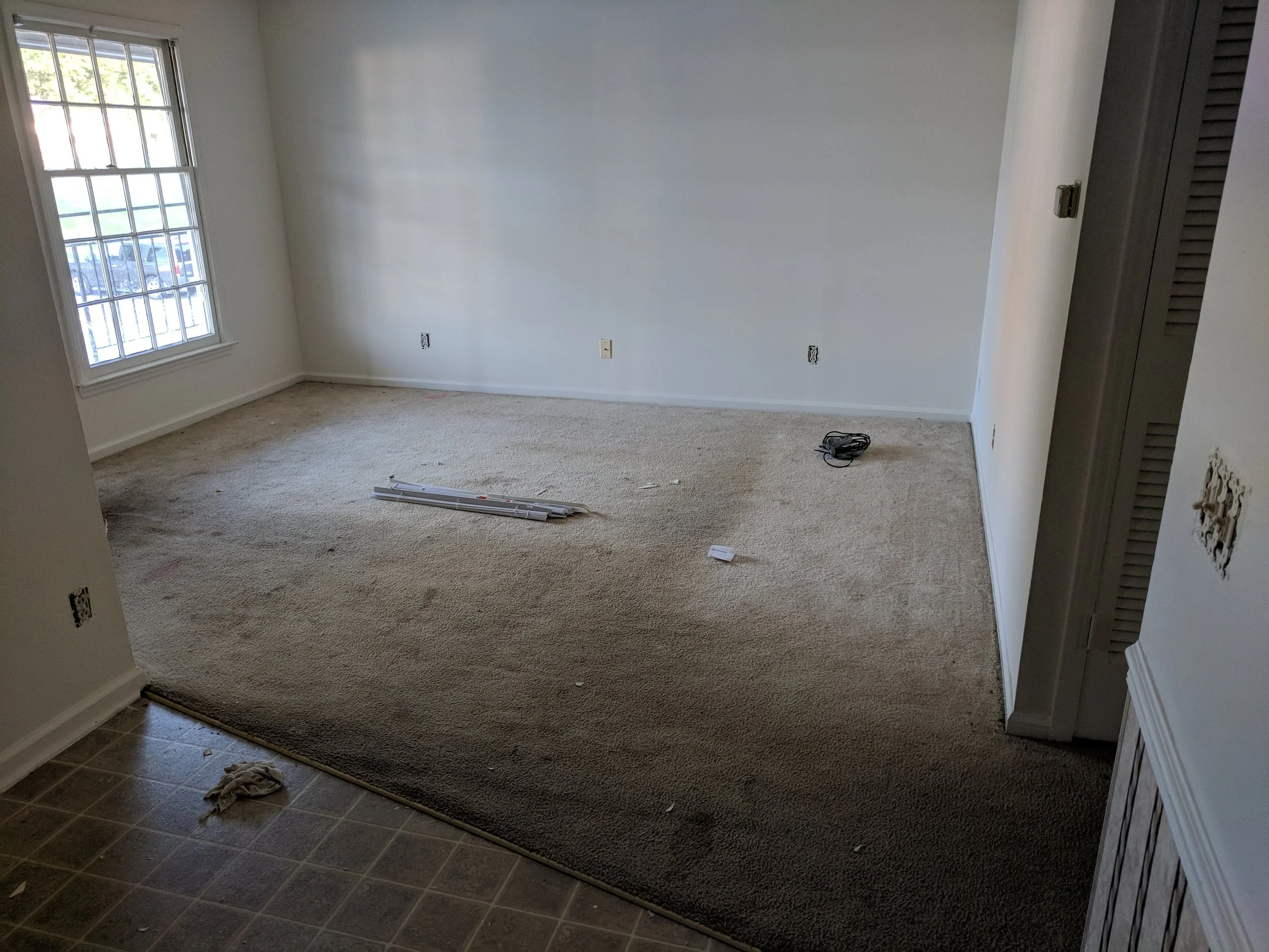 Woman aiming gun with tense expression.