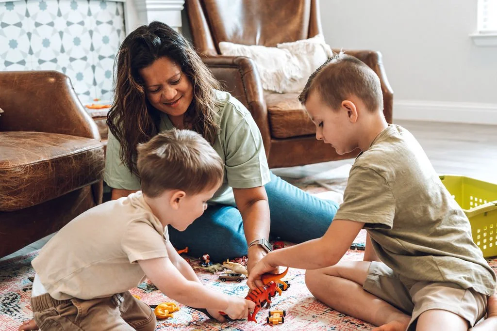 Lone Star Nanny playing with figurines with two young boys