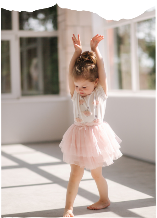 Little girl in a pink dress dancing