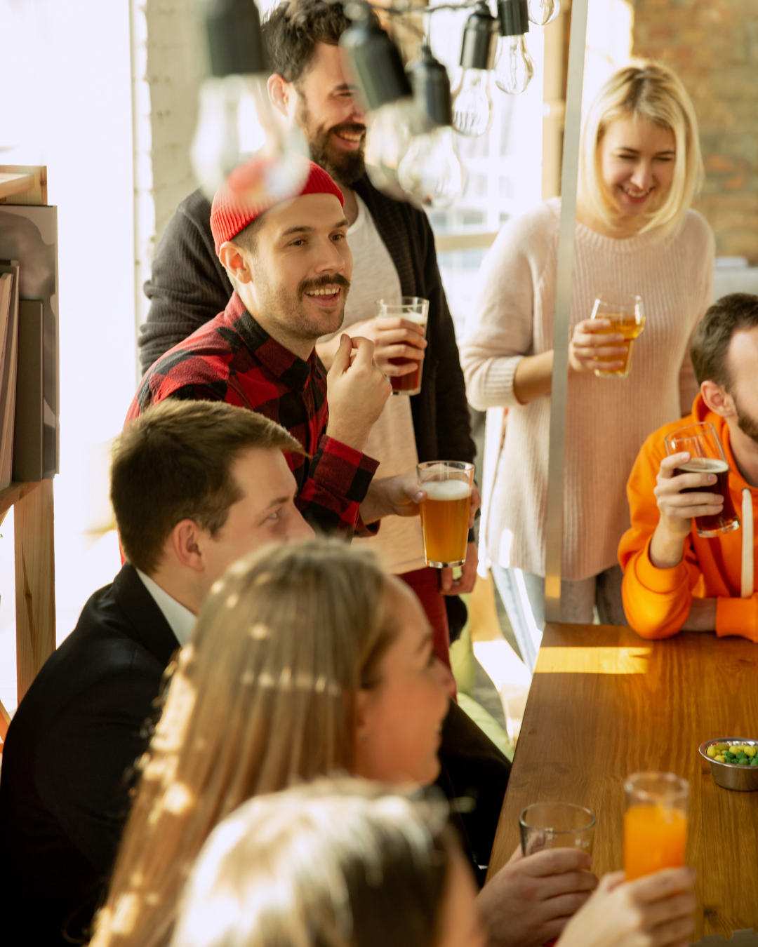 Colleagues socializing and networking at a corporate event, enjoying drinks and conversation in a relaxed professional setting.