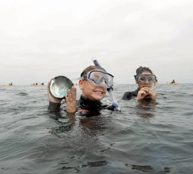 Two people enjoying a guided snorkel tour in San Diego at La Jolla cove
