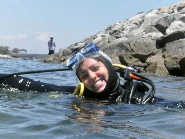 A girl smiling an having fun while on a San Diego snorkel tour at La Jolla cove