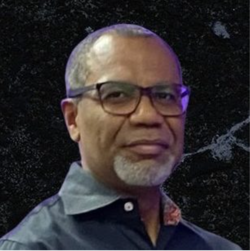 Reverend Dr. Fredy Aviles smiling in a dark blue collared shirt, representing Leadership Development for Classis de las Naciones of the Reformed Church in America