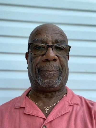 Elder Ed Smith-Green smiling in a coral shirt representing Pastoral Care for Classis de las Naciones of the Reformed Church in America