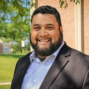 Reverend Luis Ruiz smiling in a Blue suit jacket, serving as Vice-President and International Mission for Classis de las Naciones of the Reformed Church in America