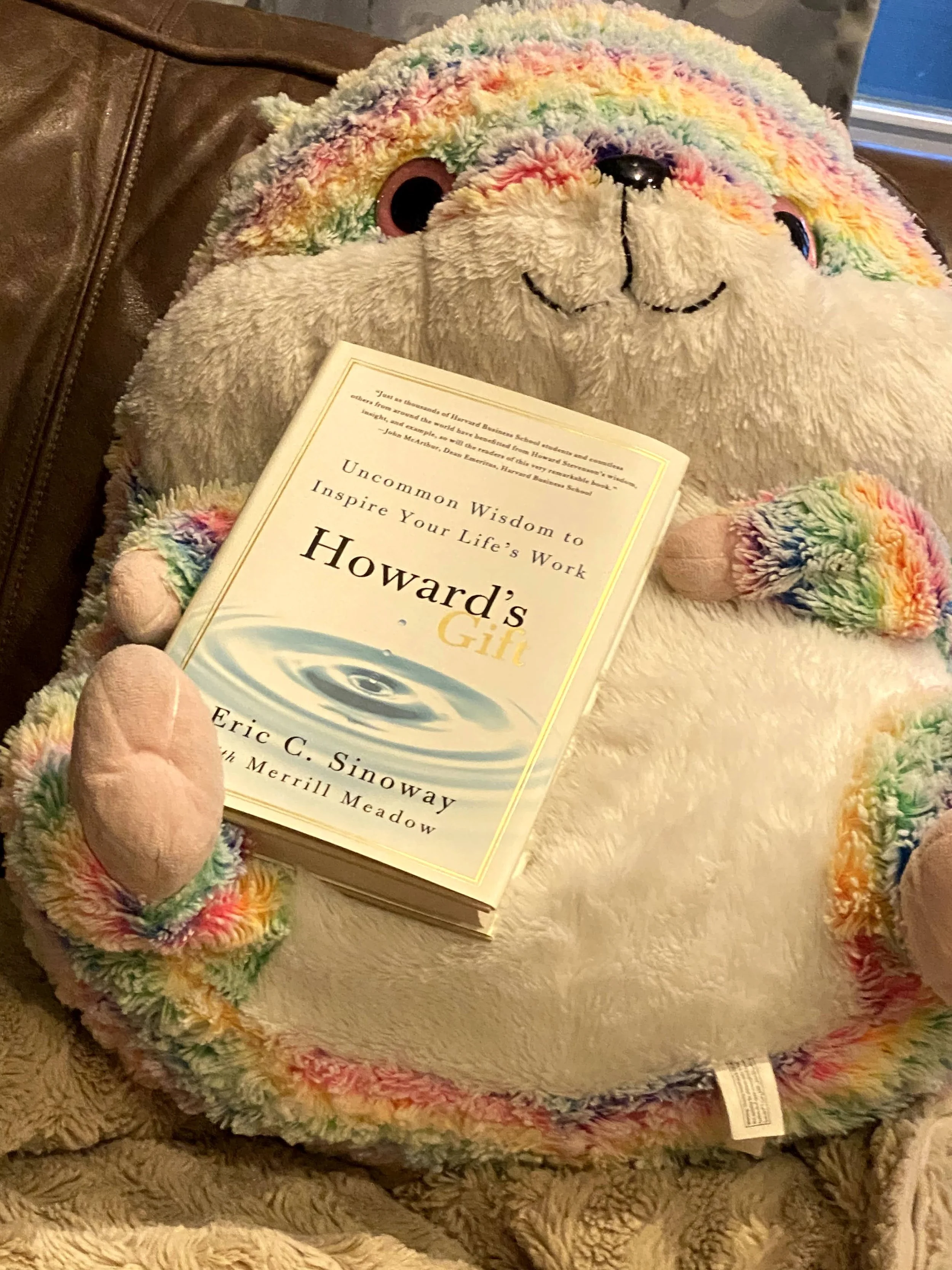 Howard's Gift book being held by stuffed animal