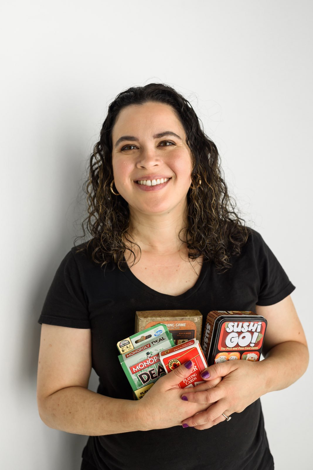 Photo of me holding miscellaneous games.